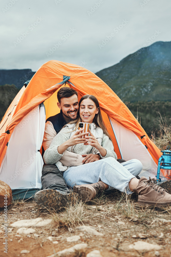 Couple, camping and relax with phone in tent for reading, social media or communication in nature. Happy, people and together in mountain, forest or woods with cellphone, contact or online connection Couple, camping and relax with phone in tent for reading, social media or communication in nature. Happy, people and together in mountain, forest or woods with cellphone, contact or online connection