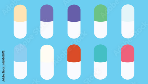 set of colored pills on light blue background. colored medicines