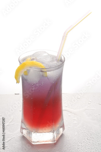 Lemon peel raspberry Cocktail Mocktail shot against a white background with props and garnish