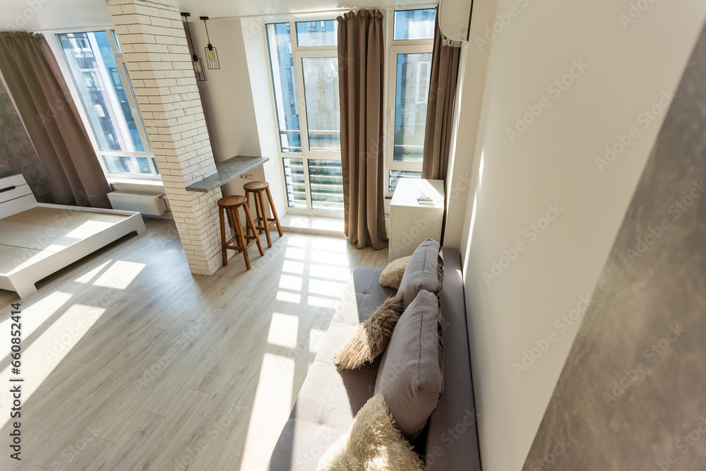Modern room, home office interior. Room with sofa, desk, chair, small table and other furniture. Modern room, home office interior. Room with sofa, desk, chair, small table and other furniture.