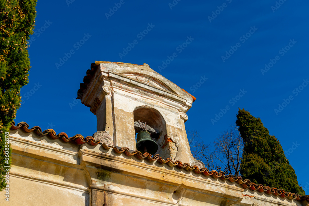 Church with Bell and a tree with Clear Blue Sky in Park San Michele in Castagnola in Lugano, Ticino in Switzerland.
