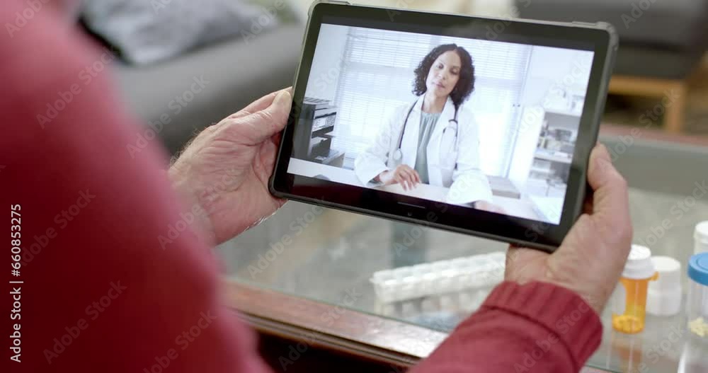 Senior caucasian man using tablet for online consultation with biracial female doctor, slow motion Senior caucasian man using tablet for online consultation with biracial female doctor, slow motion