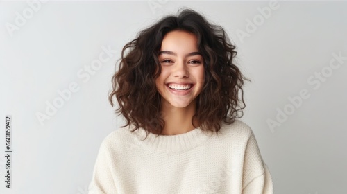 This vibrant portrait captures the joyous expression of a young teen girl in a studio setting.