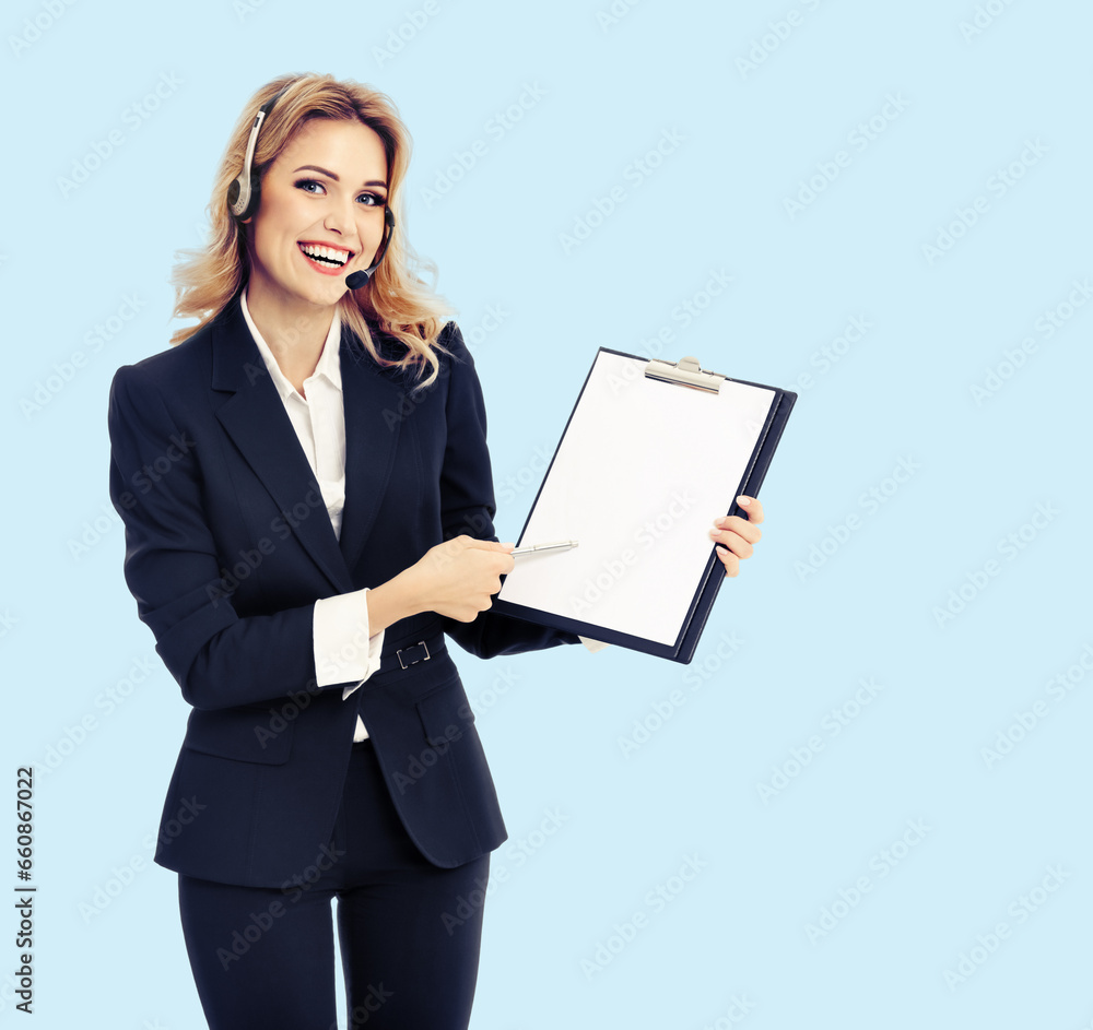 Call center. Businesswoman or female support phone operator in headset, showing blank clipboard with copy space for text, isolated bright sky blue background. Customer service help consulting concept. Call center. Businesswoman or female support phone operator in headset, showing blank clipboard with copy space for text, isolated bright sky blue background. Customer service help consulting concept.