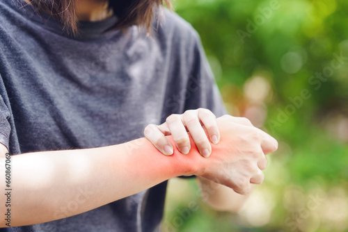 Tableau sur toile A woman grips her wrist due to a sprain causing inflammation and pain