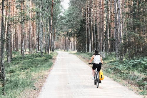 Woodland Adventure. Girl Cycling Through Nature's Beauty. Concept of recreation in nature.
