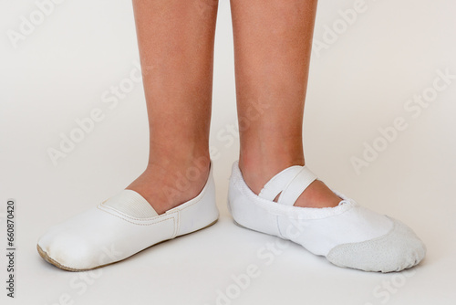 Cropped child legs in different ballet shoes