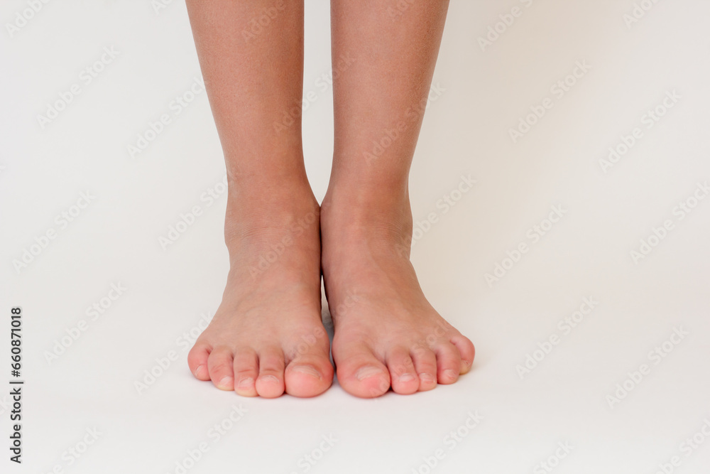 Cropped barefoot child legs on white background. Cropped barefoot child legs on white background.