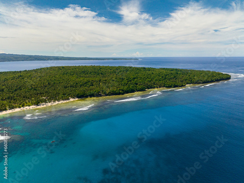 Blue sea with waves at coastal in Tropical Issland. Blue sky and clouds. Mindanao, Philippines. Seascape.