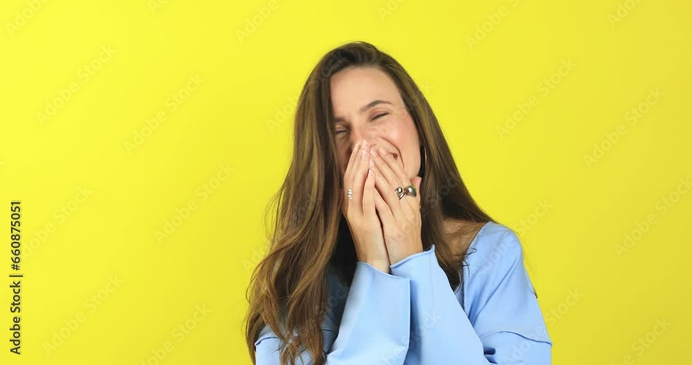 Happy joyful young woman wear blue sweater laughing out loud after hearing ridiculous anecdote, funny joke, feeling carefree amused, positive lifestyle, cover her mouth isolated on yellow background. Happy joyful young woman wear blue sweater laughing out loud after hearing ridiculous anecdote, funny joke, feeling carefree amused, positive lifestyle, cover her mouth isolated on yellow background.