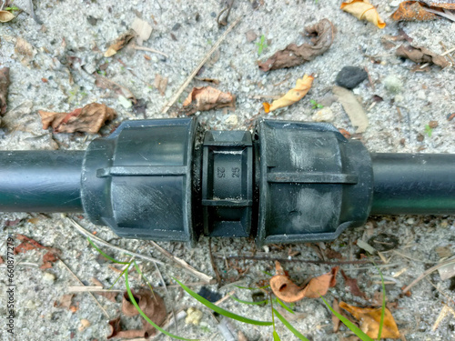 Black polypipe connector that is on the ground photo