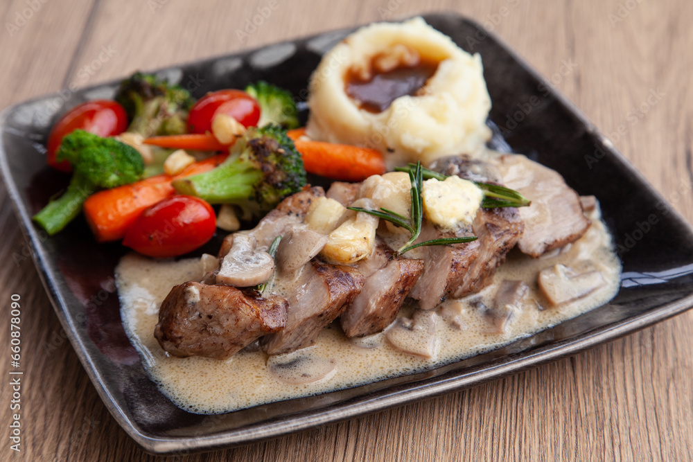 Pork shoulder steak with mushroom sauce, mashed potatoes and grilled vegetable Pork shoulder steak with mushroom sauce, mashed potatoes and grilled vegetable