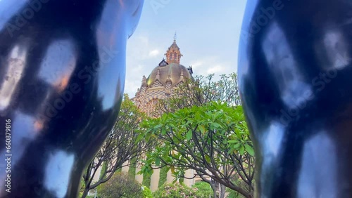 Fernando Botero square main building through legs of his sculpture in Medellin, Colombia photo