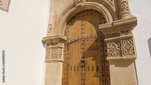 Closeup view of ornate wooden door in Rabat historic old town. POV, tilt down photo