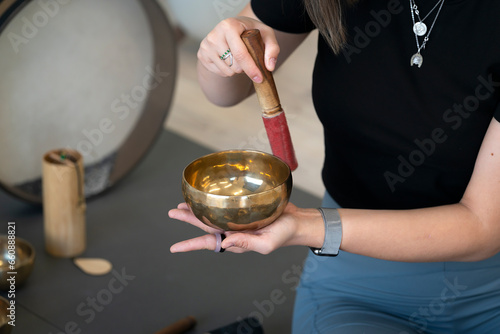 A girl plays Tibetan singing bowls.