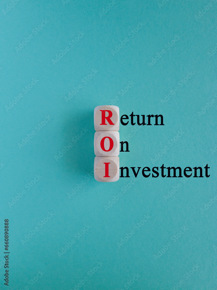 ROI text written on wooden cubes. Beautiful blue background. Return on investment concept. ROI text written on wooden cubes. Beautiful blue background. Return on investment concept.