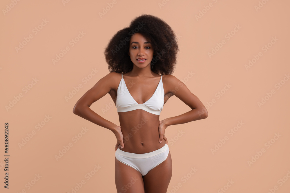 Obraz premium Beautiful woman in stylish bikini on beige background