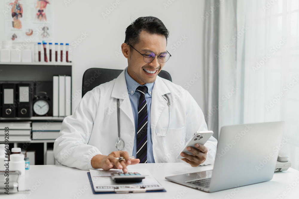 Doctor working in hospital use calculator, Healthcare and medical concept. Doctor working in hospital use calculator, Healthcare and medical concept.