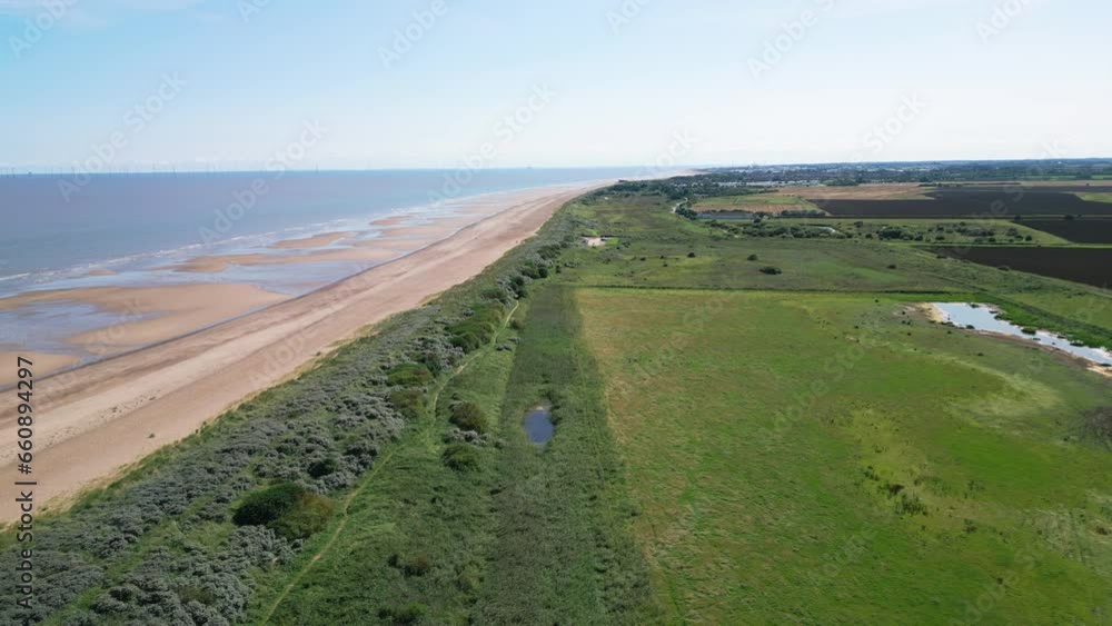 Video from above captures the splendor of the saltwater marshes along the Lincolnshire coast, showcasing seabirds soaring and perching on the lagoons and inland lakes. Video from above captures the splendor of the saltwater marshes along the Lincolnshire coast, showcasing seabirds soaring and perching on the lagoons and inland lakes.