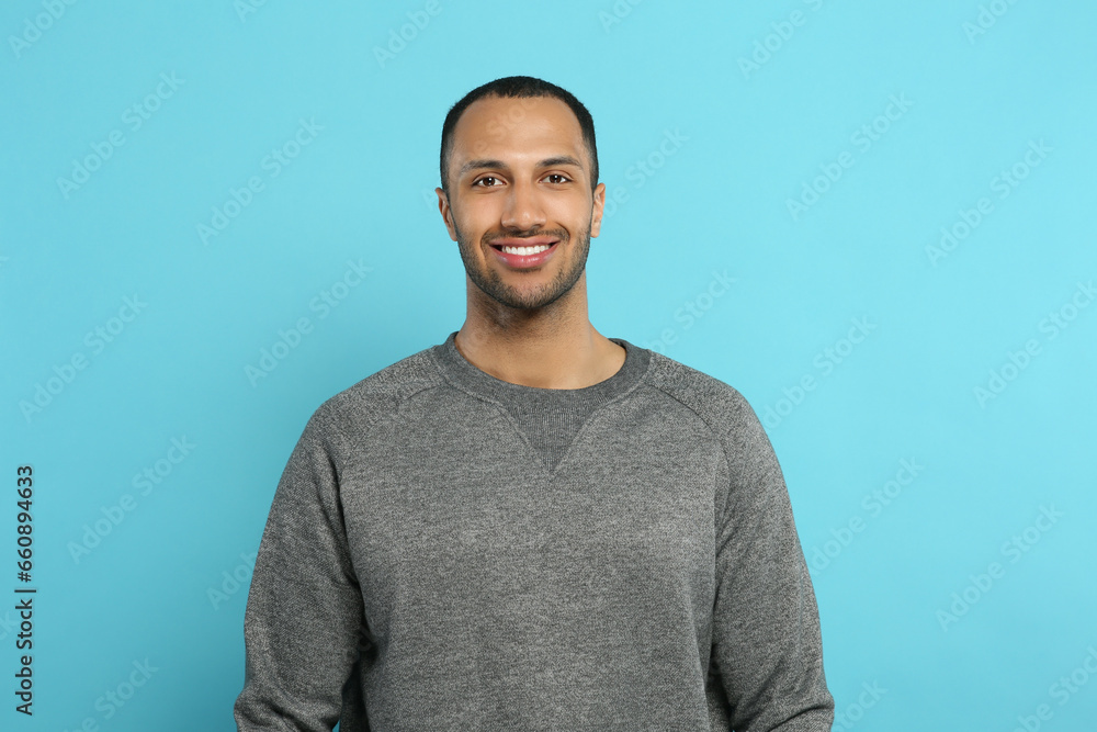 Portrait of handsome young man on light blue background Portrait of handsome young man on light blue background