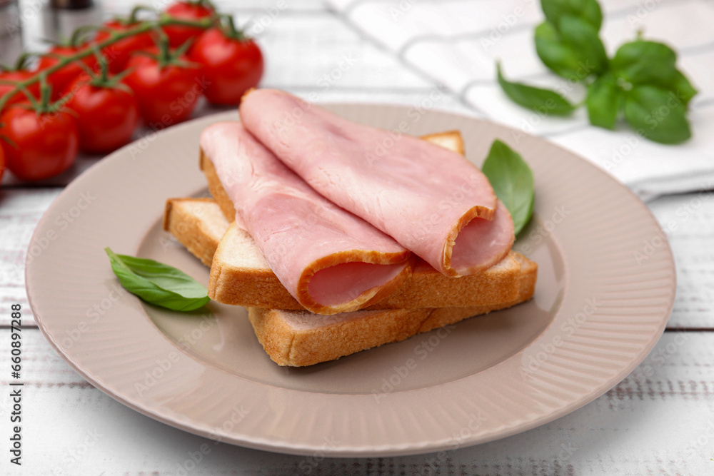 Delicious sandwich with ham on white wooden table, closeup