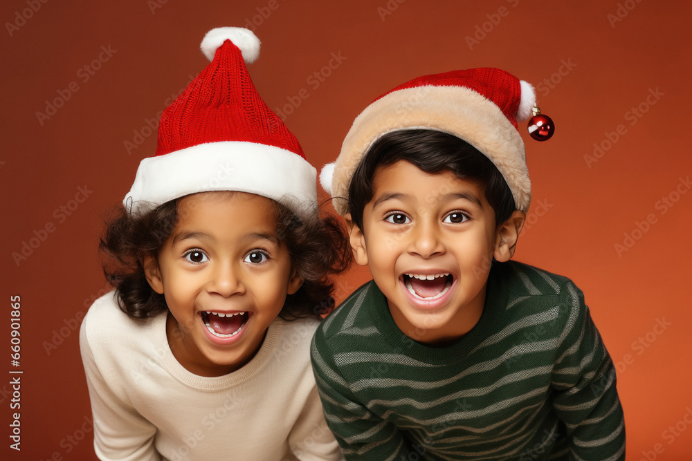 Two little children wearing santa hat and celebrating christmas Two little children wearing santa hat and celebrating christmas