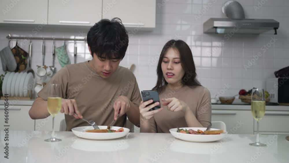 Young couple is shopping online in kitchen. Lifestyle and leisure activity concept. Young couple is shopping online in kitchen. Lifestyle and leisure activity concept.