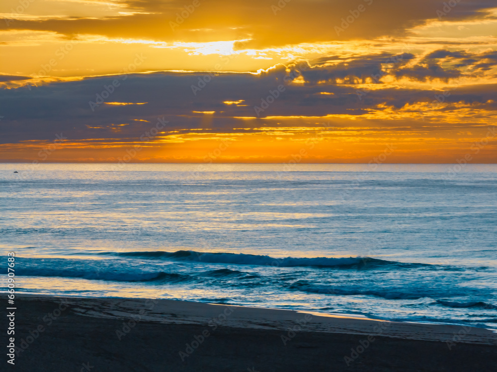 Fototapeta premium Aerial sunrise over the sea, beach and lagoon