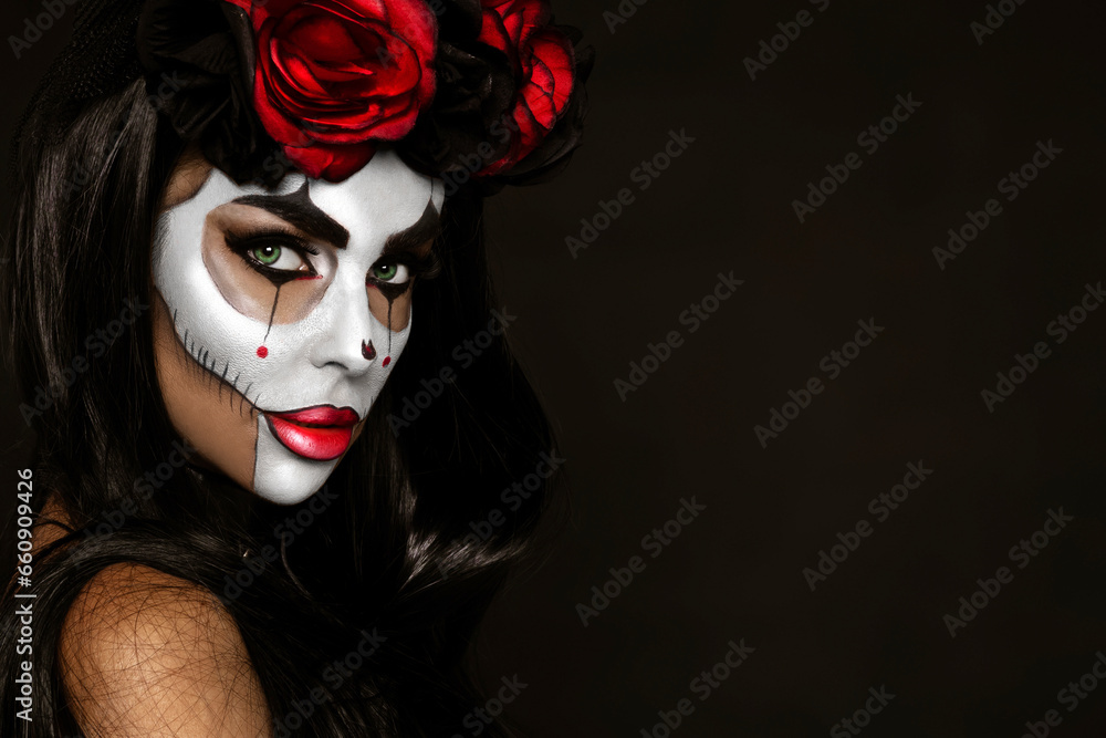 Sexy woman in a Halloween makeup and costume on black background. Halloween makeup and costume concept.