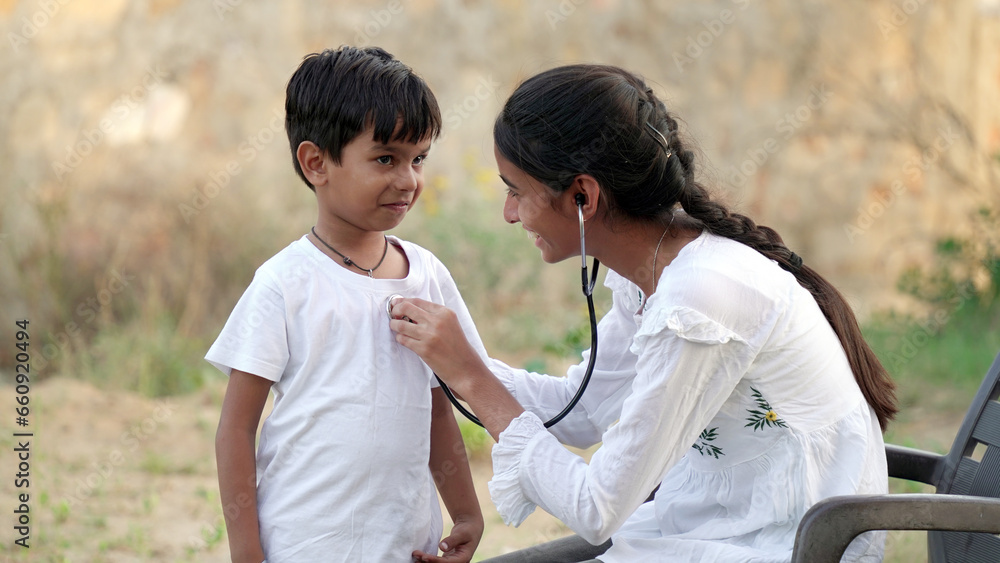 Health checkup, Children medical insurance care. Indian young doctor of pediatrician holding stethoscope checking heartbeat