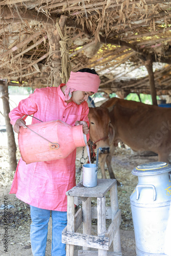 happy Indian farmer selling milk in farm photo