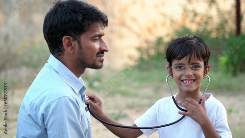Health checkup, Children medical insurance care. Indian kid doctor of pediatrician holding stethoscope checking heartbeat © Govind