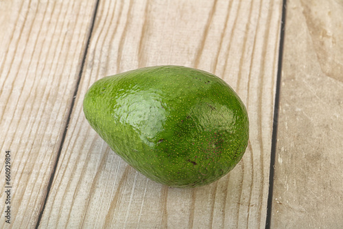 Ripe green avocado over background