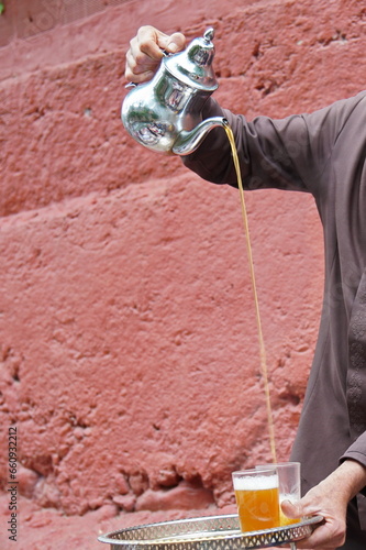 pouring tea from traditional teapot in Morocco