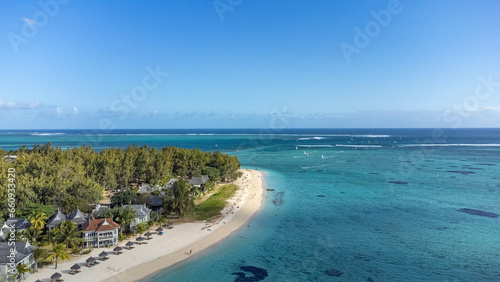Le Morne tropical beach and famous kite, surf spot aerial panoramic view with palm trees and white sand blue ocean and sunbeds with umbrellas, Mauritius © Alexey Pelikh