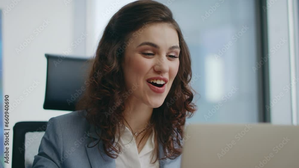 Emotional employee video calling at office laptop looking web camera close up. Emotional employee video calling at office laptop looking web camera close up.