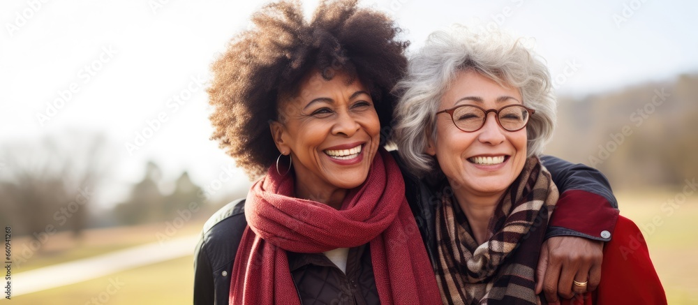 Fototapeta premium Senior women of different races enjoying outdoor activities and embracing each other in the park With copyspace for text