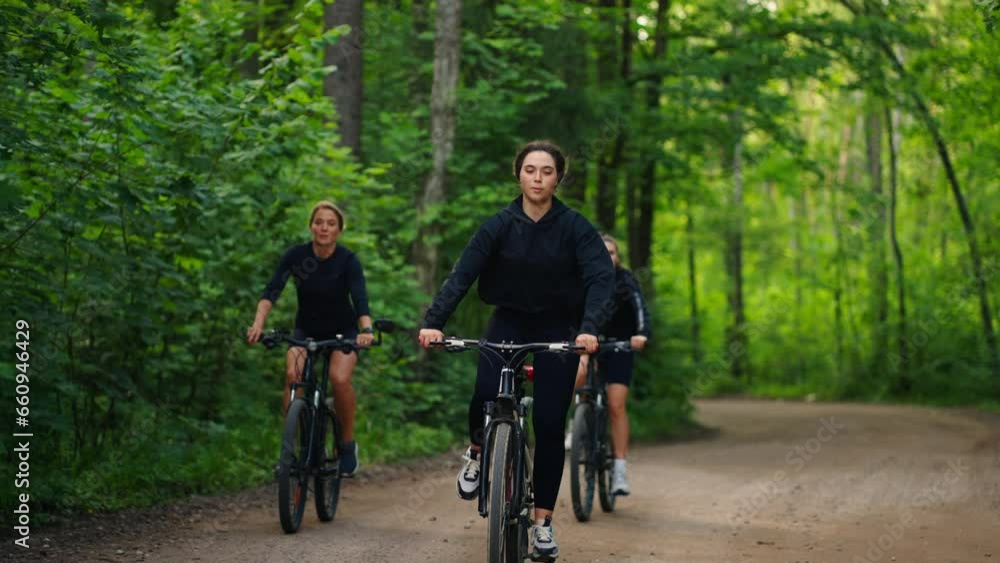 Sport And Active Pastime In Weekend, Group Of Young Women Riding Bicycles In Beautiful Forest Sport And Active Pastime In Weekend, Group Of Young Women Riding Bicycles In Beautiful Forest