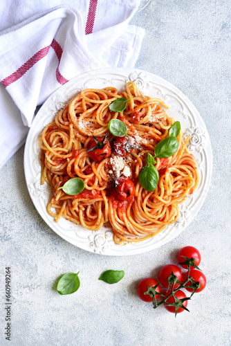 Spaghetti with grilled tomatoes. Top view with copy space.