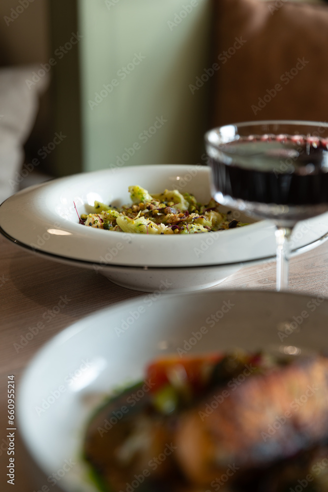 italian pasta on a wooden table with red wine light from the window italian pasta on a wooden table with red wine light from the window