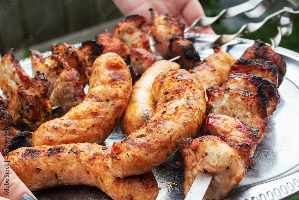Meat and sausage on a grill closeup Meat and sausage on a grill closeup
