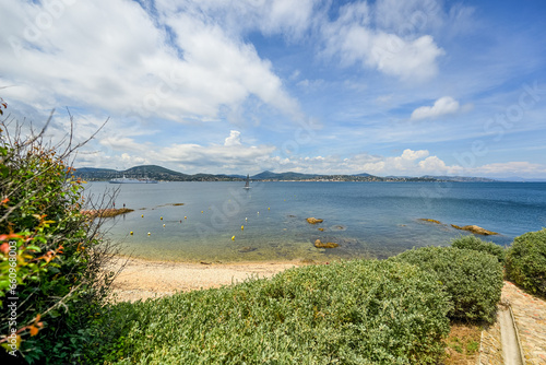 View of the bay of Saint-Tropez with mountains on the background on a sunny day and cloudy sky - June 2018 - Saint-Tropez, French Riviera (Côte d'Azur), France