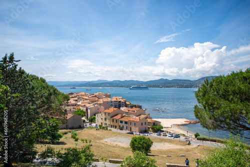 View of the bay of Saint-Tropez with mountains on the background on a sunny day and cloudy sky - June 2018 - Saint-Tropez, French Riviera (Côte d'Azur), France