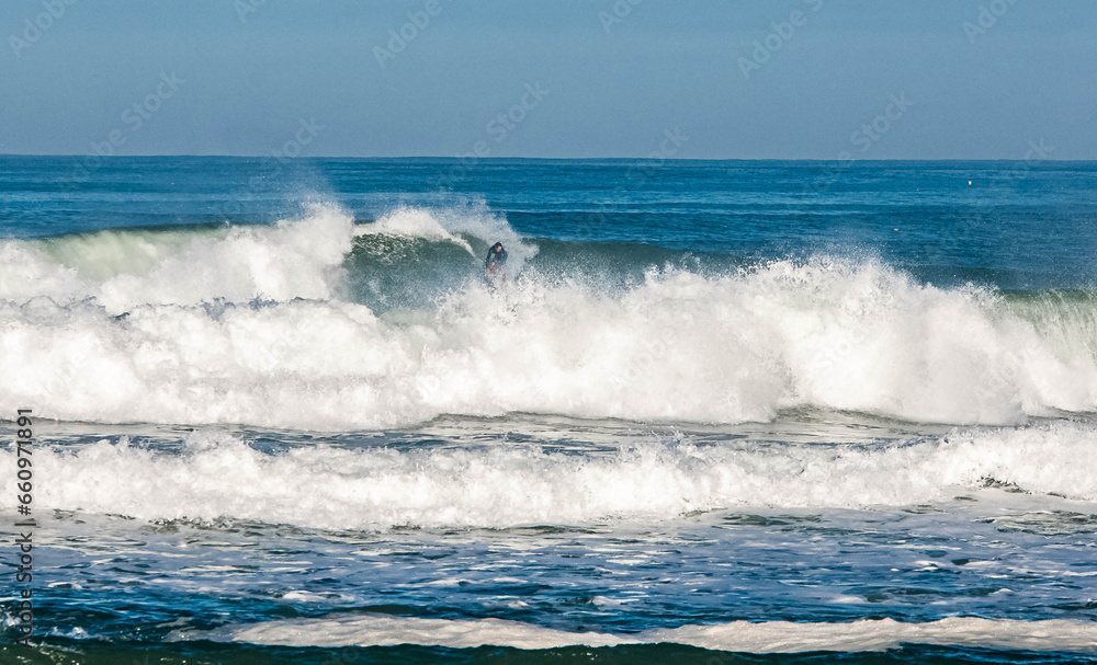 Surfing in action before being crushed by big waves