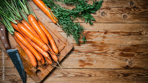 Fresh carrots on wooden table.