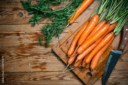 Fresh carrots on wooden table.