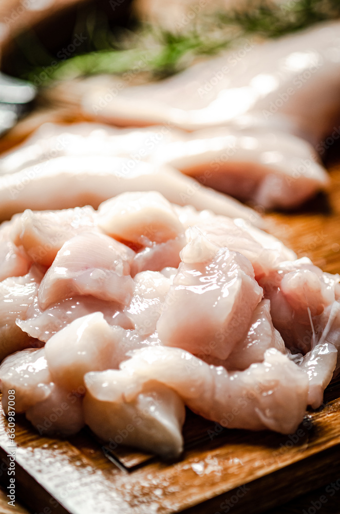 Sliced chicken fillet. On cutting board. Sliced chicken fillet. On cutting board.
