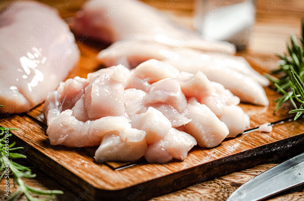 Sliced chicken fillet. On cutting board.