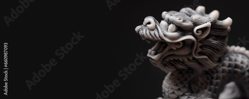 Gray dragon statue on a black background. The symbol of 2024. Happy Chinese New Year.