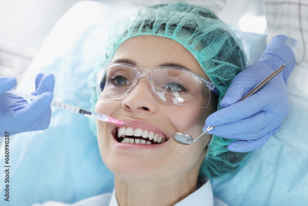Doctor gives woman an anesthetic injection. Painkillers and anti-aging drugs in medicine concept Doctor gives woman an anesthetic injection. Painkillers and anti-aging drugs in medicine concept